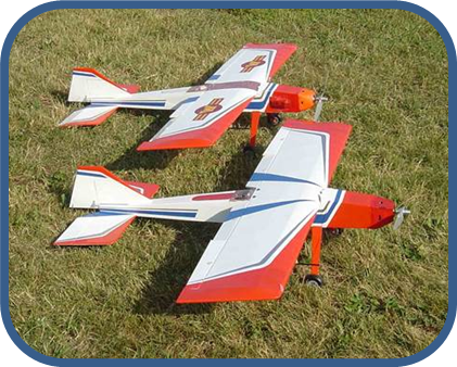 Two red, white, and blue small airplanes